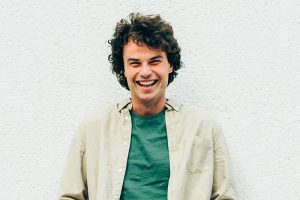 Handsome Young Man With Curly Hair Smiling